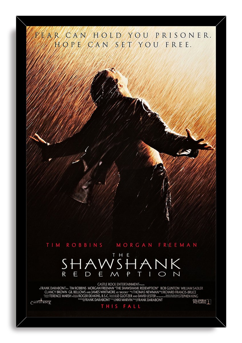 The Shawshank Redemption framed wall art print depicts Andy Dufresne raising his arms in golden rain inside a black frame.