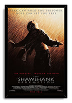 The Shawshank Redemption framed wall art print portrays Andy Dufresne with open arms in golden rain inside a black frame.