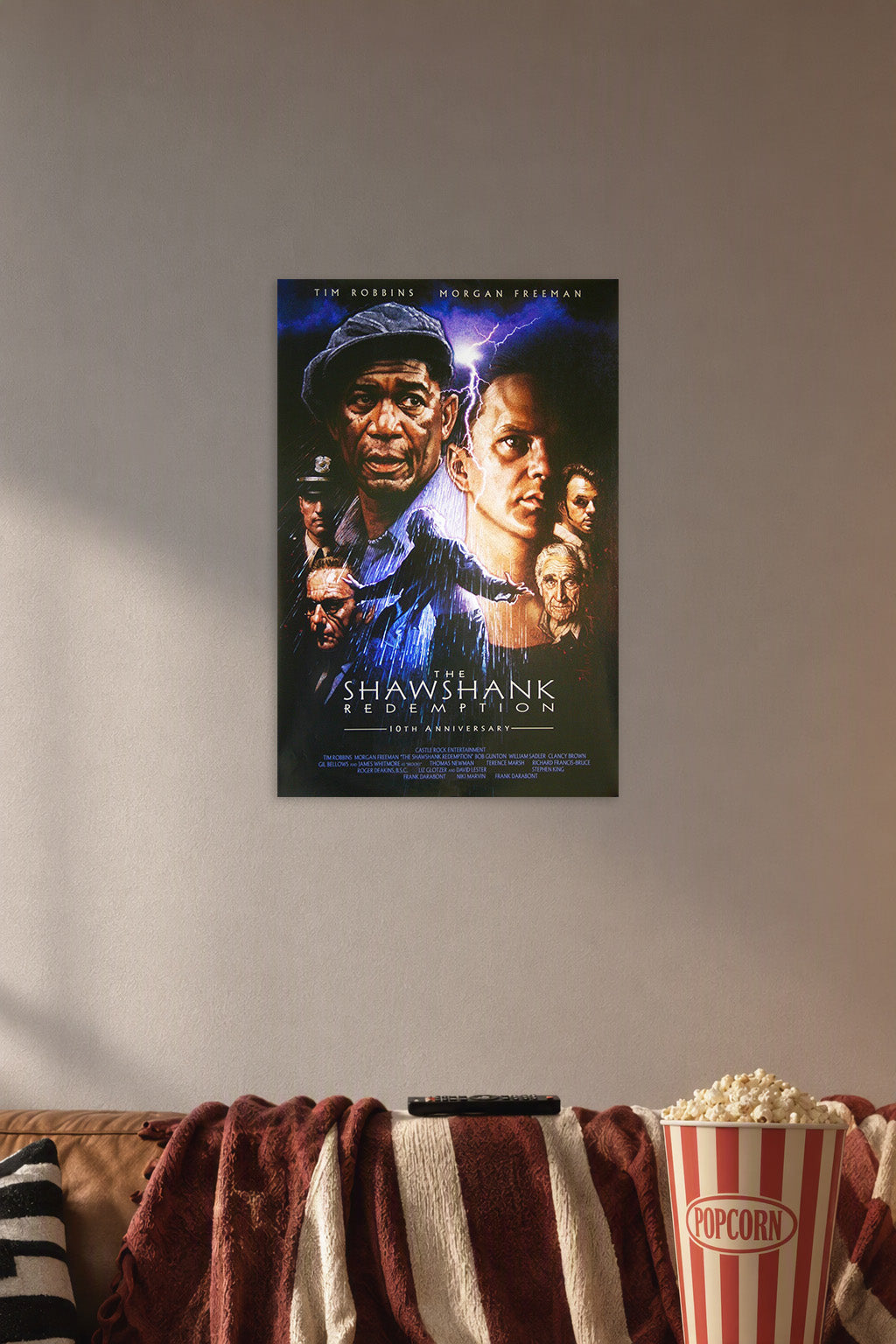 The Shawshank Redemption Movie Poster in a cozy movie room above a brown sofa with popcorn.