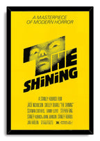 The Shining framed wall art print presents the yellow-and-black poster with a stylized male face inside a glossy black frame.