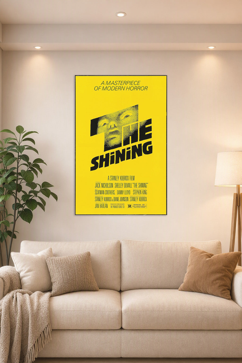 The Shining Movie Poster in a bright living room above a beige sofa.