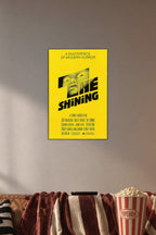 The Shining Movie Poster in a cozy movie room above a brown sofa with popcorn.
