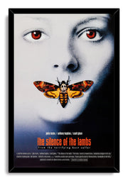 The Silence of the Lambs framed wall art print features a red-eyed face, orange skull-marked moth, and black border frame.
