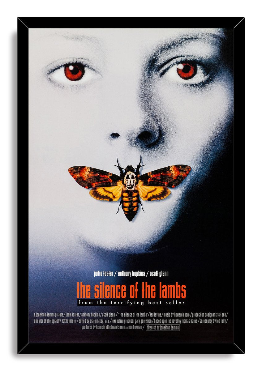 The Silence of the Lambs framed wall art print features a red-eyed face, orange skull-marked moth, and black border frame.