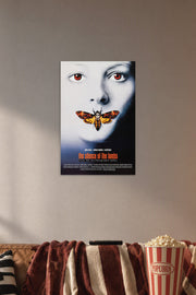 The Silence of the Lambs Movie Poster in a cozy movie room above a brown sofa with popcorn.