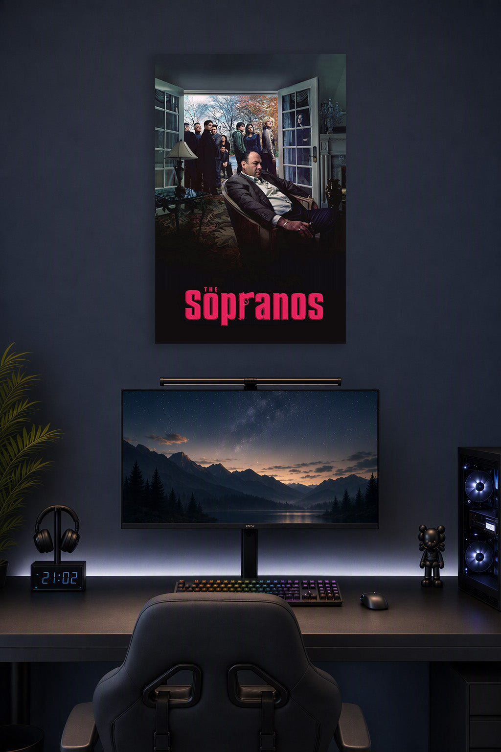The Sopranos in a gaming desk setup above a monitor.