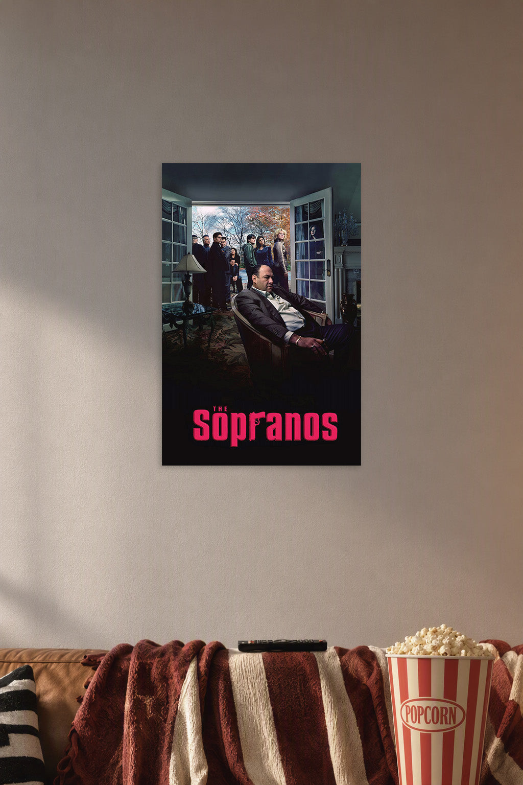 The Sopranos in a cozy movie room above a brown sofa with popcorn.