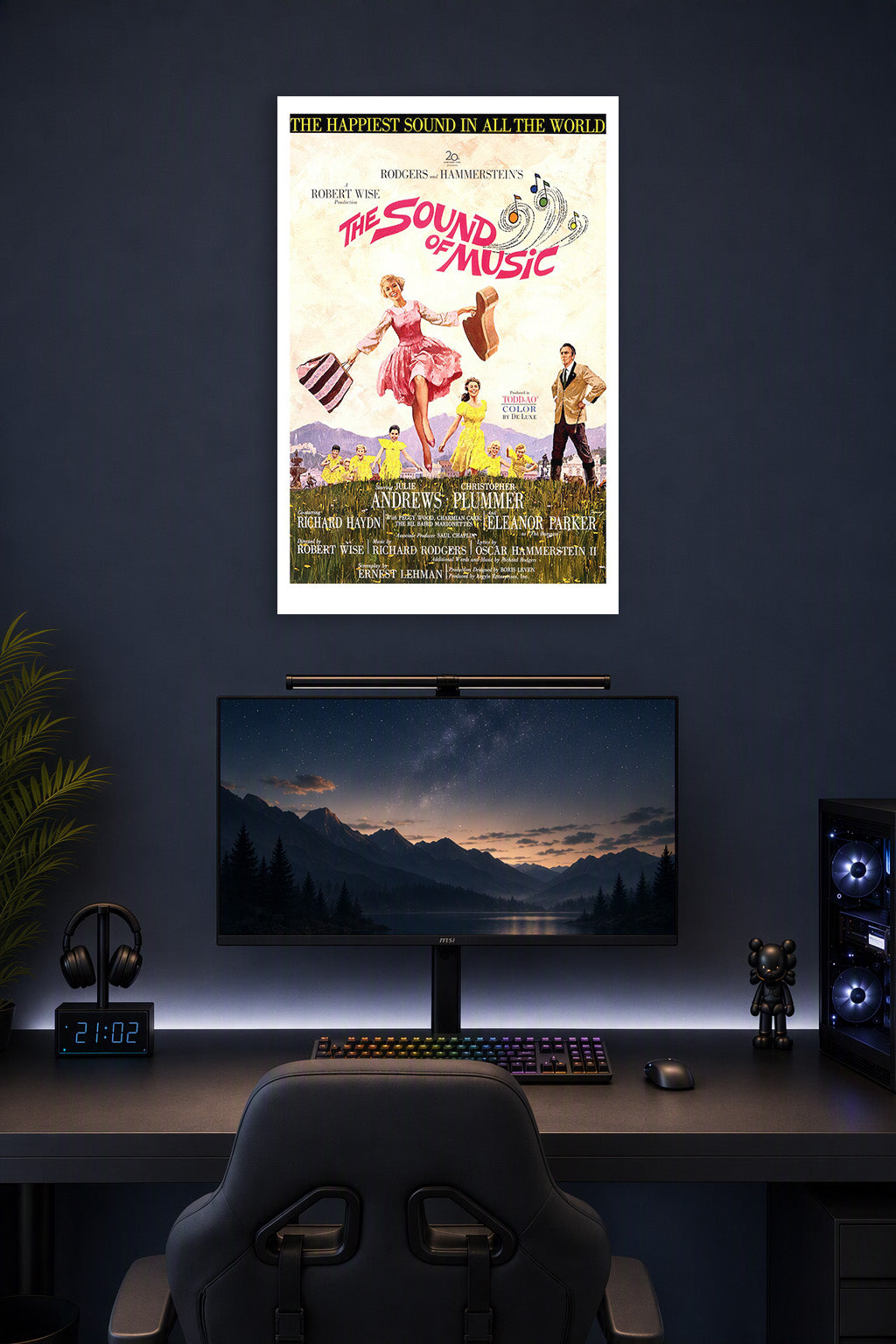 The Sound of Music Movie Poster in a gaming desk setup above a monitor.