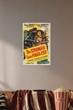 The Stranger from Ponca City Charles Starrett Smiley Burnette Western Movie in a cozy movie room above a brown sofa with popcorn.