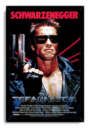 The Terminator framed wall art print portrays Arnold Schwarzenegger gripping a shotgun in sunglasses and a black leather jacket.