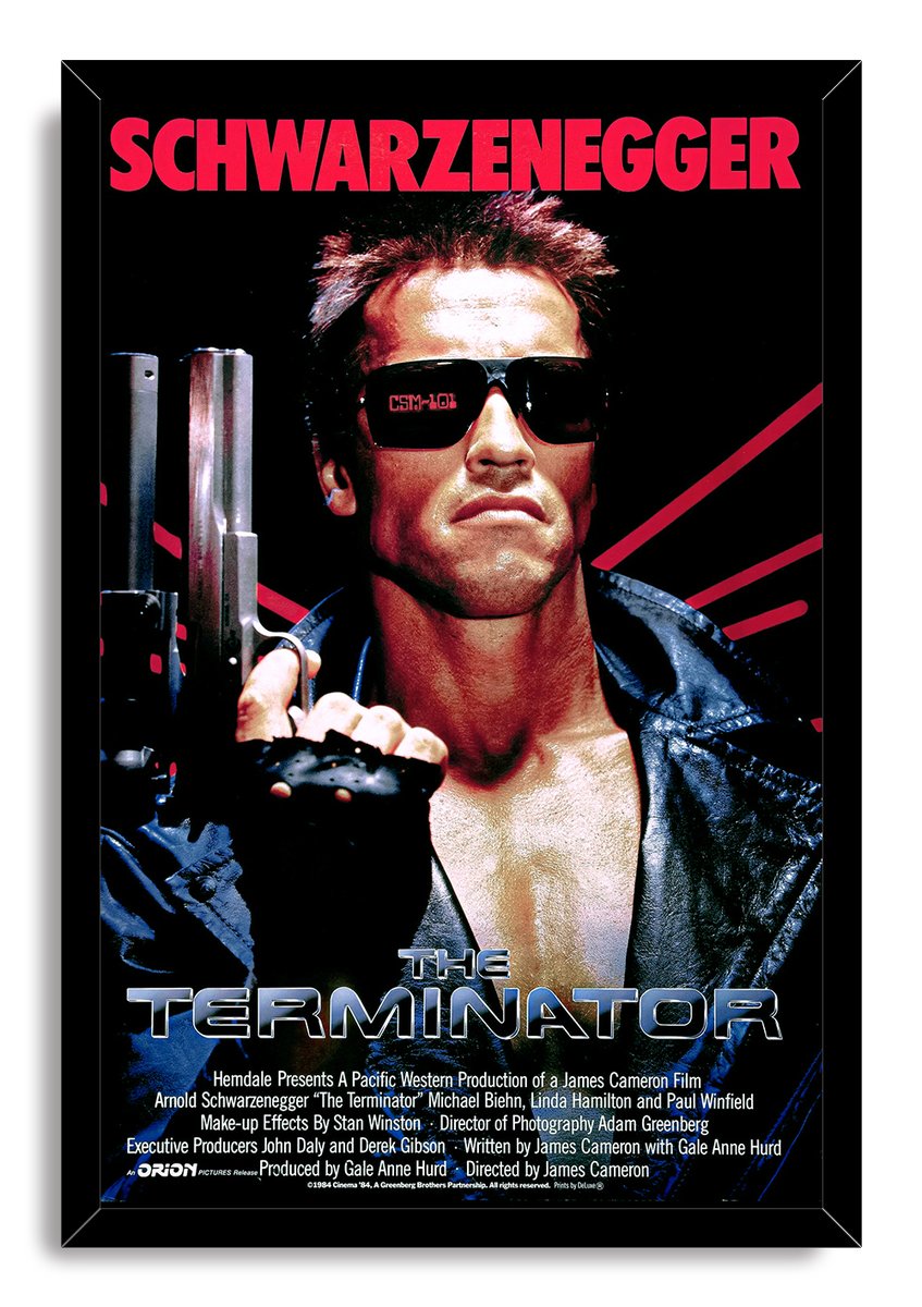The Terminator framed wall art print portrays Arnold Schwarzenegger gripping a shotgun in sunglasses and a black leather jacket.