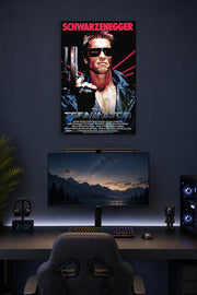 The Terminator Arnold Schwarzenegger in a gaming desk setup above a monitor.