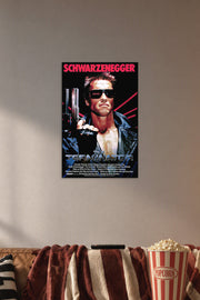 The Terminator Arnold Schwarzenegger in a cozy movie room above a brown sofa with popcorn.