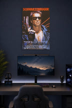 The Terminator Arnold Schwarzenegger in a gaming desk setup above a monitor.