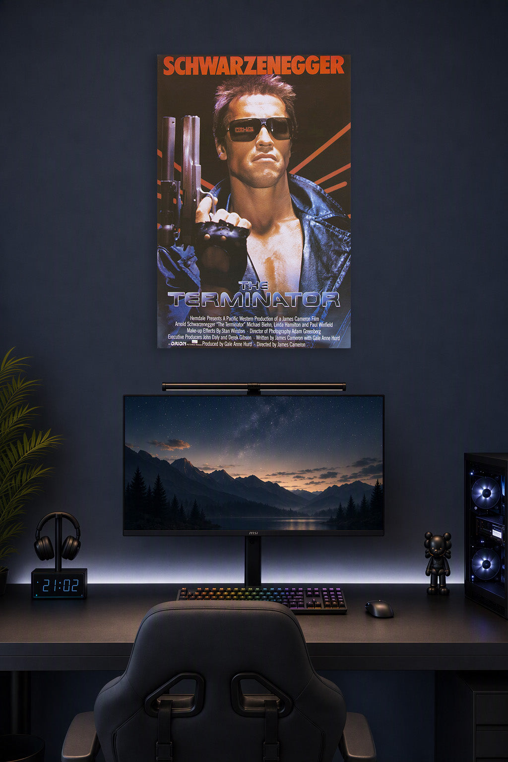 The Terminator Arnold Schwarzenegger in a gaming desk setup above a monitor.