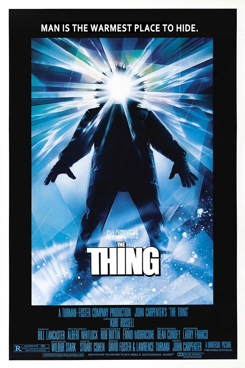 The Thing movie poster wall art print features a dark parka-clad figure with a blazing white face amid icy blue rays.