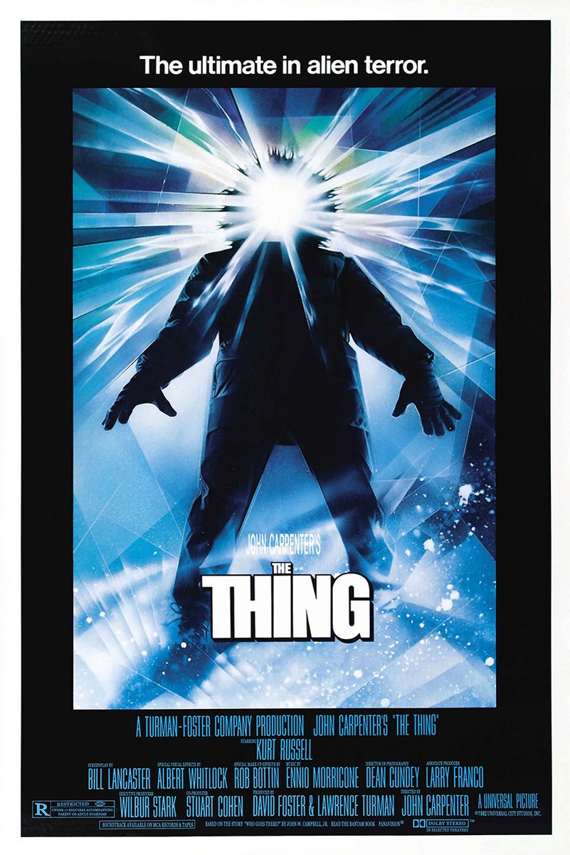 The Thing movie poster wall art print featuring a dark-clad figure with a blinding white face amid radiating blue ice-like beams.