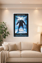 The Thing Movie Poster in a bright living room above a beige sofa.