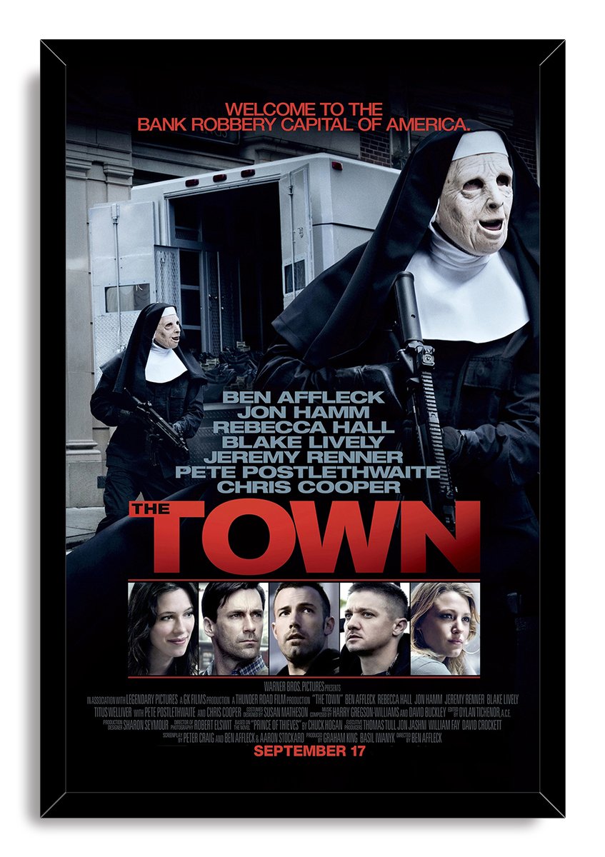The Town framed wall art print presents two masked nun robbers with guns, an armored truck, actor portraits, and red lettering.