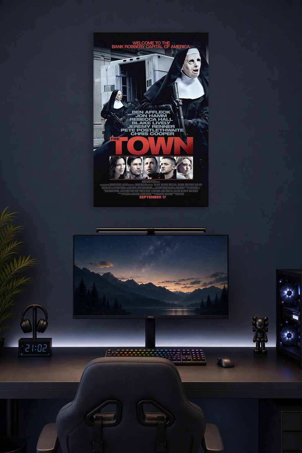 The Town Movie Poster in a gaming desk setup above a monitor.