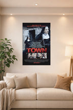 The Town Movie Poster in a bright living room above a beige sofa.