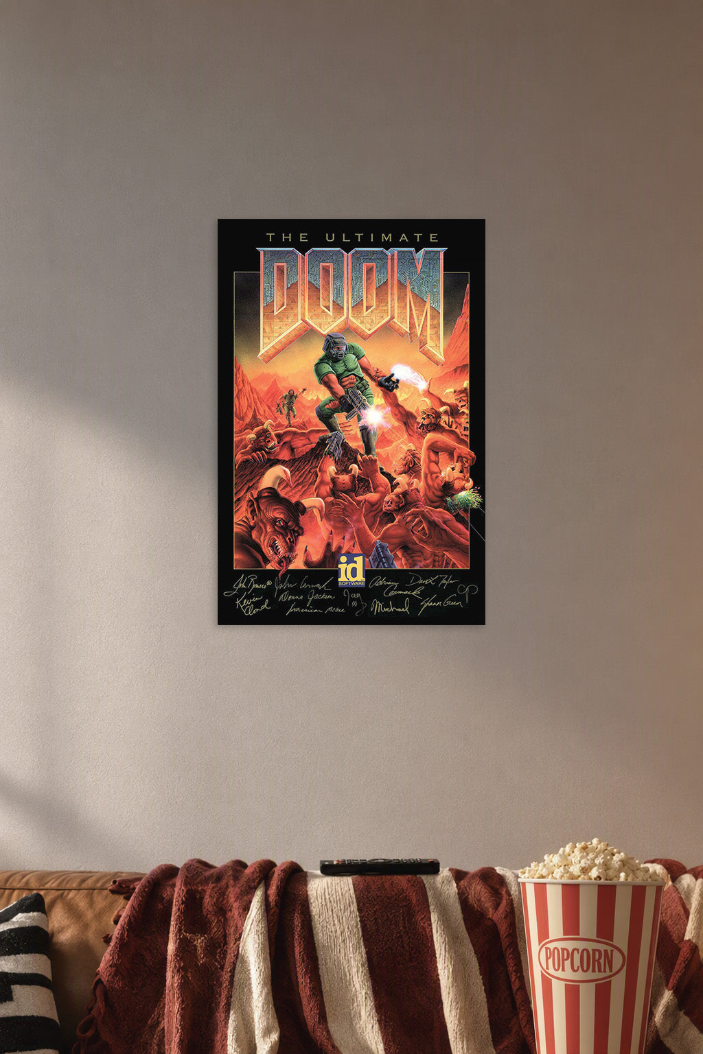 The Ultimate Doom Game Art in a cozy movie room above a brown sofa with popcorn.