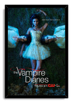 The Vampire Diaries framed wall art print depicts a woman in a white dress lying between two men on dark grass, in blue-toned light.