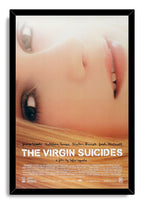 The Virgin Suicides framed wall art print presents a hazy close-up blonde portrait, white title lettering, and a black frame.
