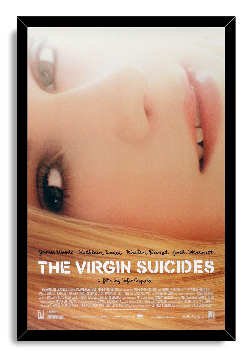 The Virgin Suicides framed wall art print presents a hazy close-up blonde portrait, white title lettering, and a black frame.