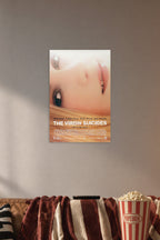 The Virgin Suicides Movie Poster in a cozy movie room above a brown sofa with popcorn.