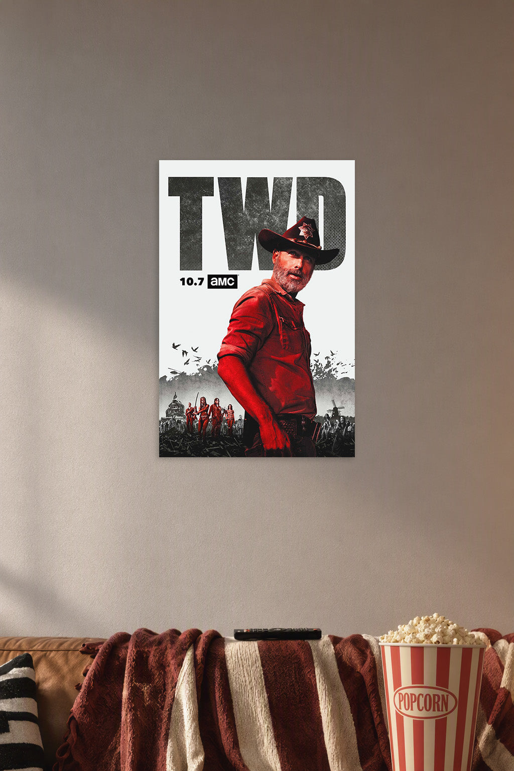 The Walking Dead Rick Grimes in a cozy movie room above a brown sofa with popcorn.
