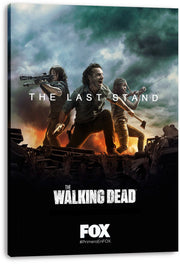 The Walking Dead canvas wall art print viewed from an angle, featuring three survivors with weapons amid flames, wreckage, and raised hands.