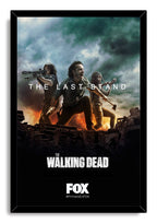 The Walking Dead framed wall art print, The Last Stand, depicting three survivors defending themselves above wreckage under a dark, smoky sky.