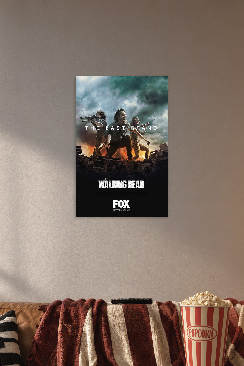 The Walking Dead 'The Last Stand' in a cozy movie room above a brown sofa with popcorn.