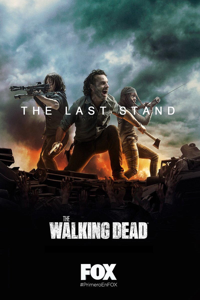 The Walking Dead poster, The Last Stand, with three armed survivors atop wreckage as hands reach up beneath storm clouds and fire.