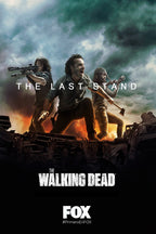 The Walking Dead poster, The Last Stand, with three armed survivors atop wreckage as hands reach up beneath storm clouds and fire.