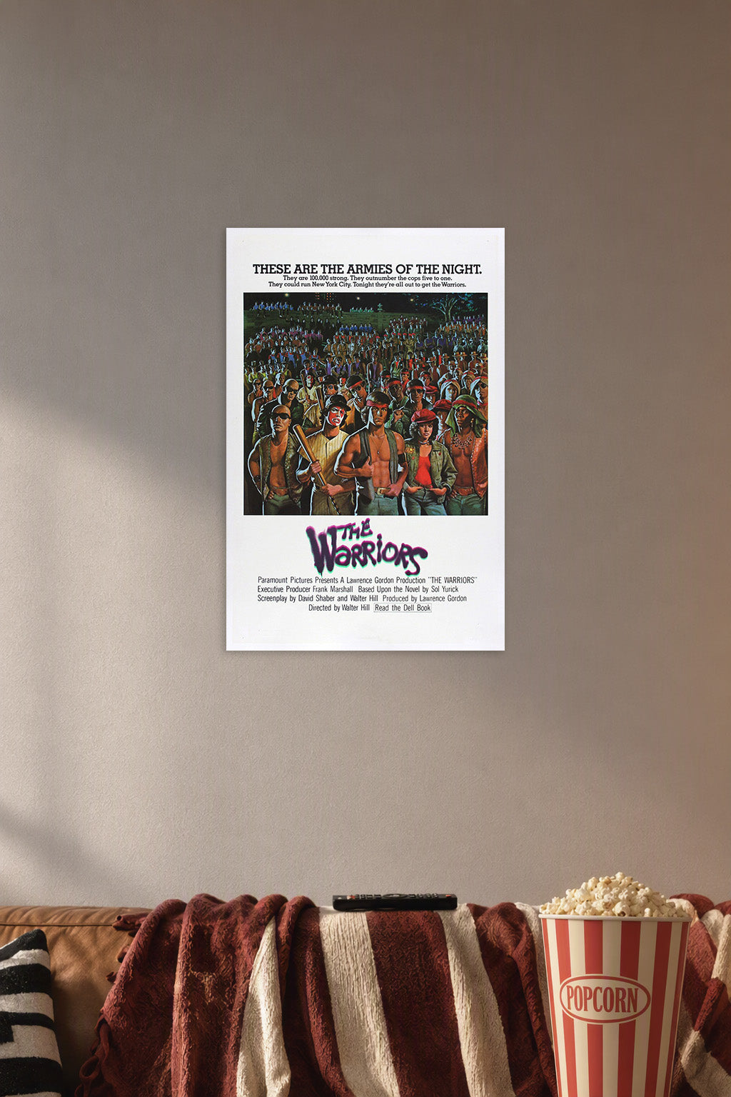The Warriors in a cozy movie room above a brown sofa with popcorn.