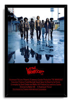 The Warriors framed wall art print features seven people on a rain-slick city street, mirrored in puddles above red film credits.