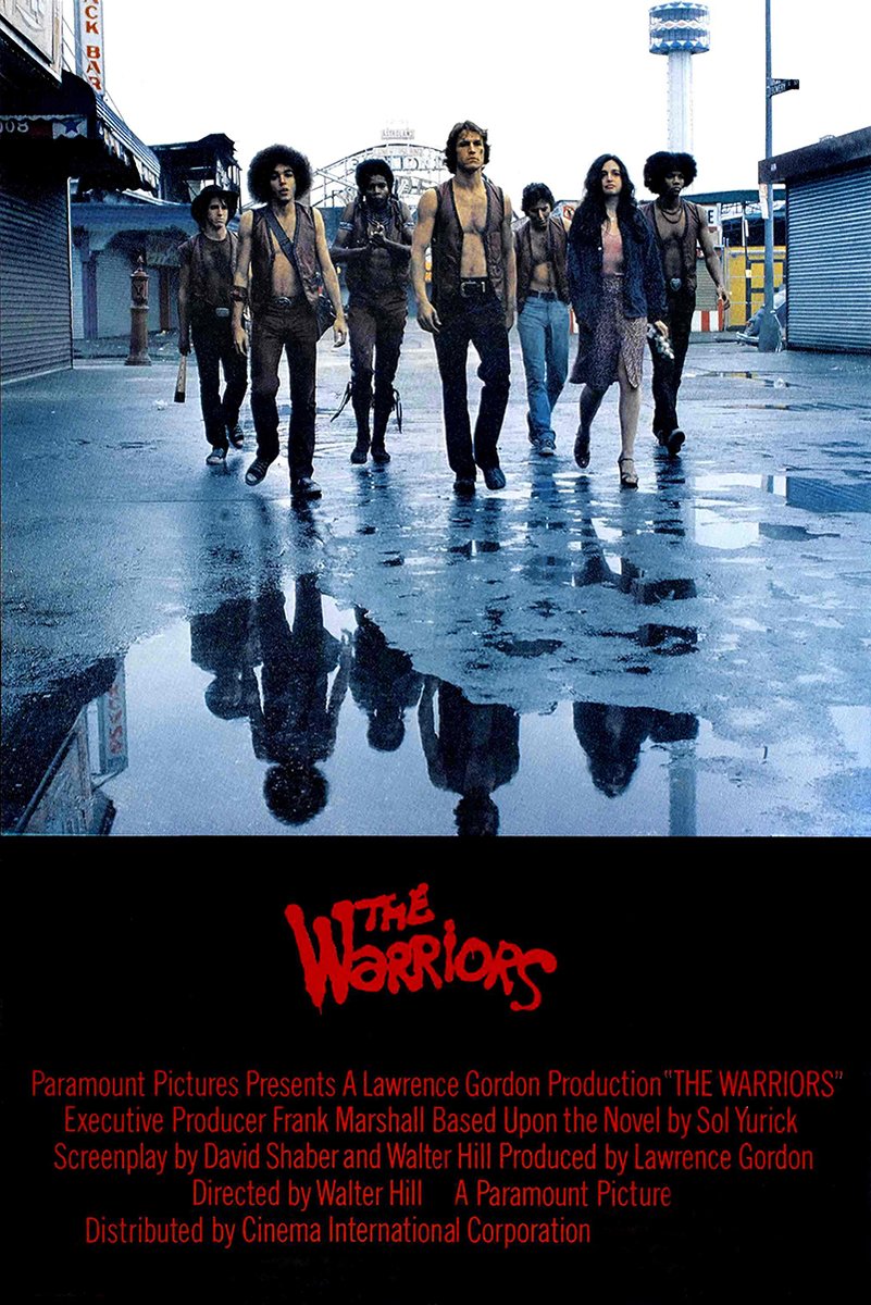 The Warriors movie poster depicts seven streetwise figures walking through a rain-soaked urban street, reflected in puddles above red credits.