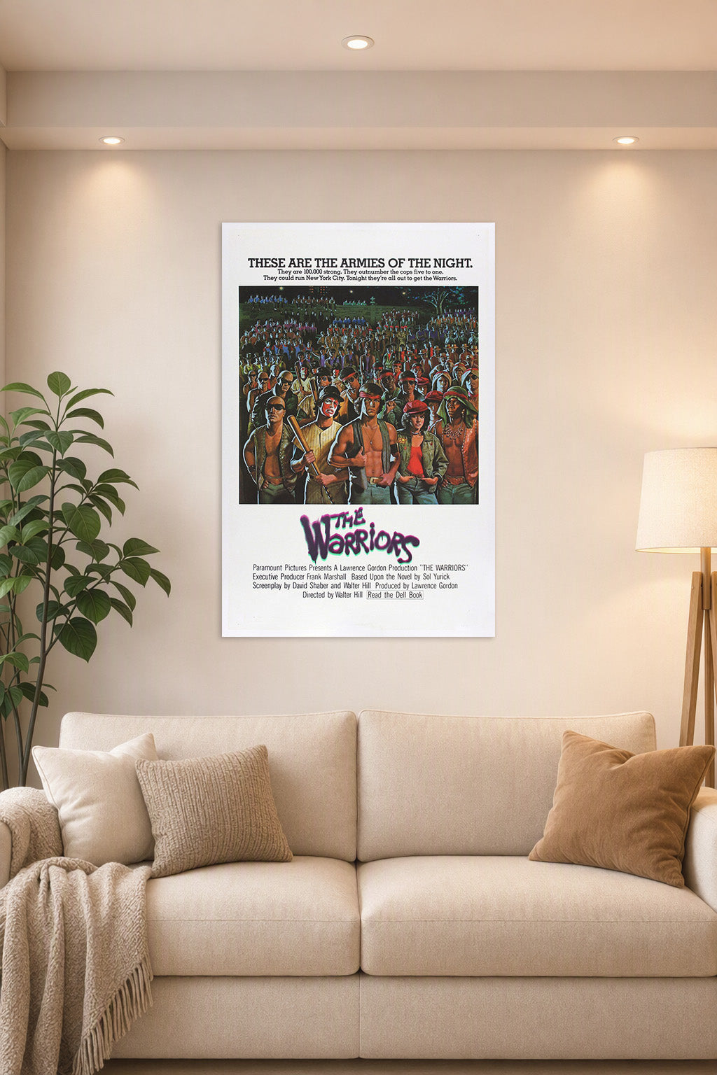 The Warriors Movie Poster in a bright living room above a beige sofa.