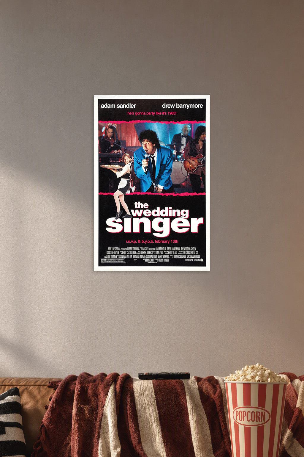 The Wedding Singer Movies in a cozy movie room above a brown sofa with popcorn.