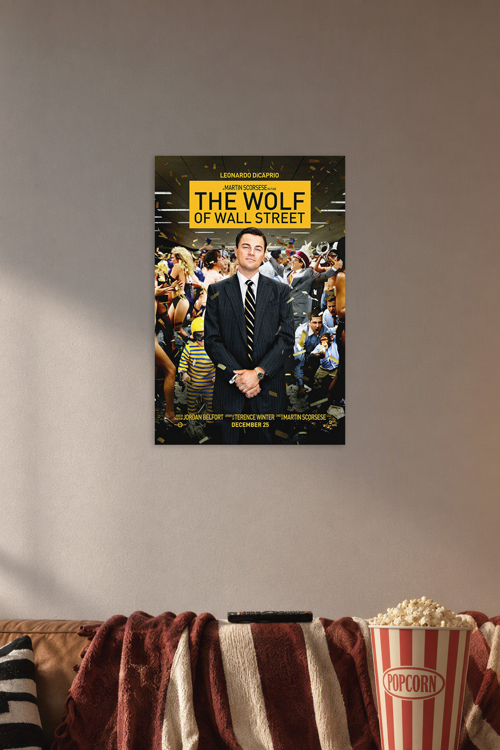 The Wolf of Wall Street Movie in a cozy movie room above a brown sofa with popcorn.