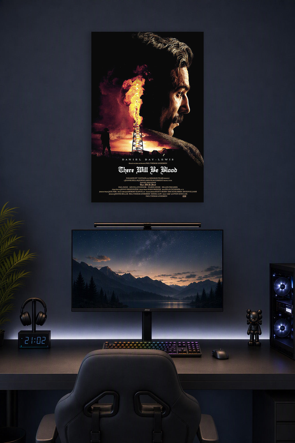 There Will Be Blood in a gaming desk setup above a monitor.