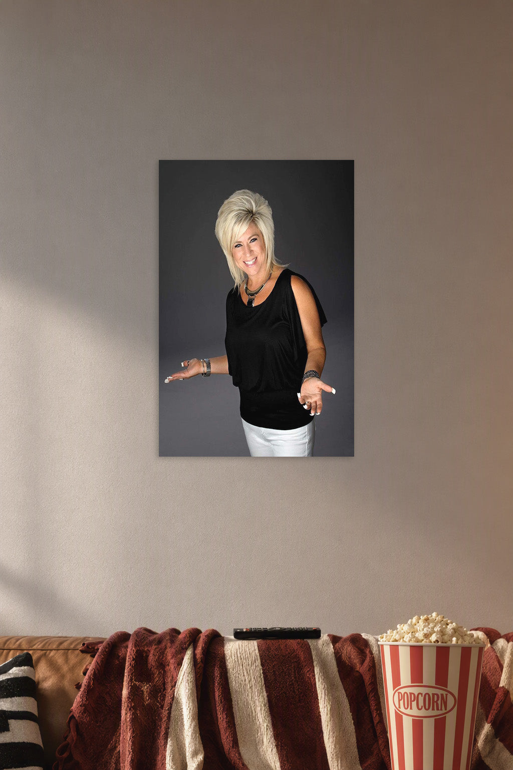 Theresa Caputo in a cozy movie room above a brown sofa with popcorn.