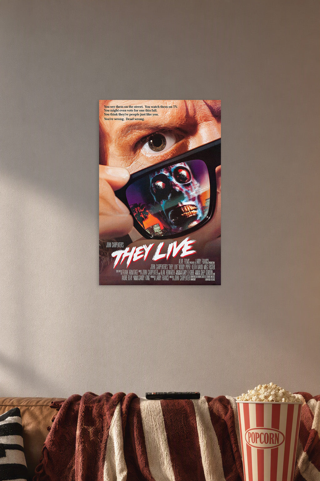 They Live Movie Poster in a cozy movie room above a brown sofa with popcorn.