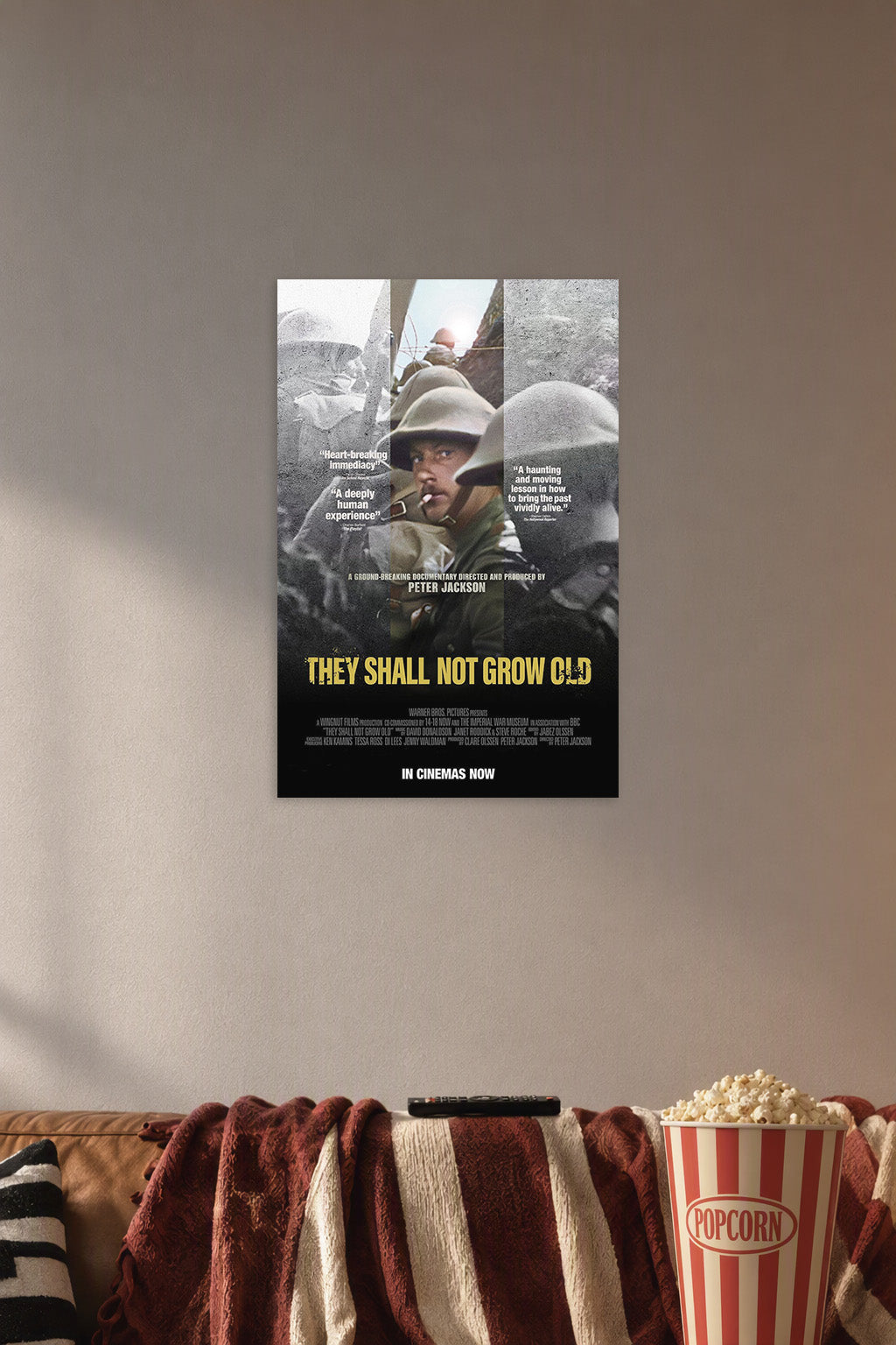 They Shall Not Grow Old Movie Poster in a cozy movie room above a brown sofa with popcorn.