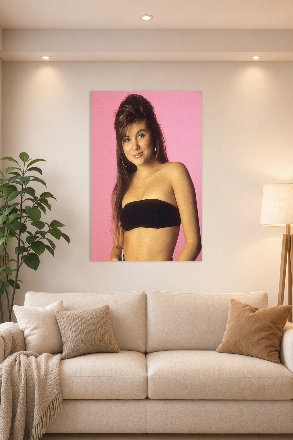 Tiffani Thiessen in a bright living room above a beige sofa.