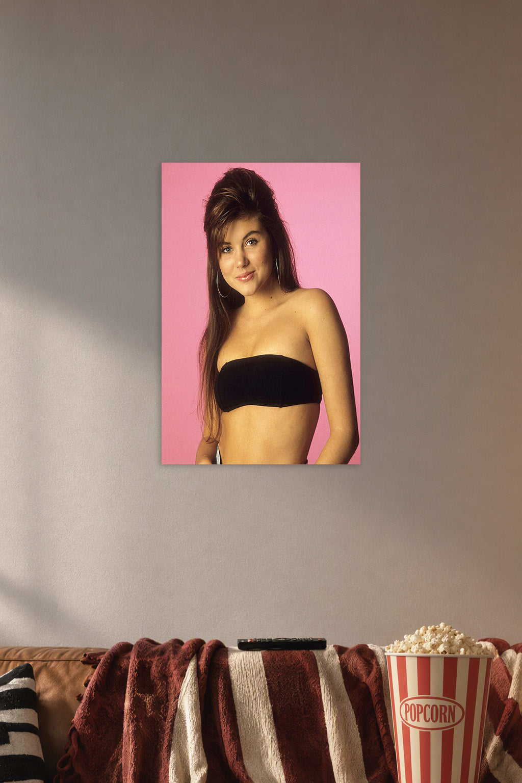 Tiffani Thiessen in a cozy movie room above a brown sofa with popcorn.