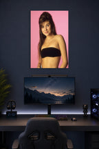 Tiffani Thiessen in a gaming desk setup above a monitor.