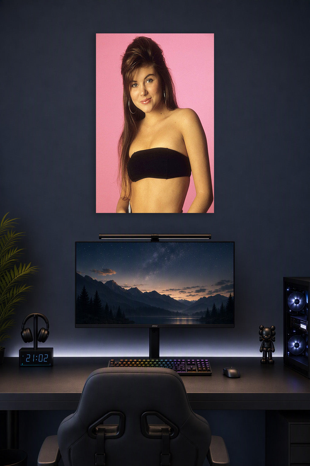 Tiffani Thiessen in a gaming desk setup above a monitor.